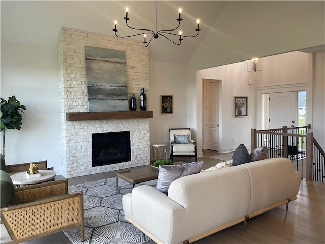 18300 Monrovia St, Overland Park, KS 66013 - living room featuring wood finished floors, high vaulted ceiling, a chandelier, and a stone fireplace