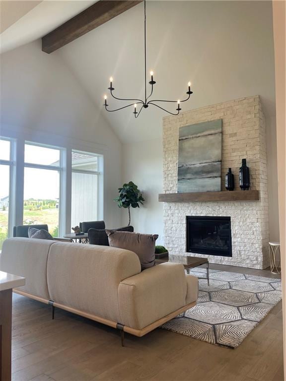 18300 Monrovia St, Overland Park, KS 66013 - living area with high vaulted ceiling, beam ceiling, healthy amount of natural light, a chandelier, and wood finished floors