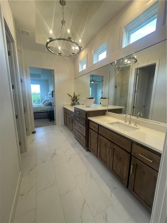 18300 Monrovia St, Overland Park, KS 66013 - ensuite bathroom with a chandelier, marble look tile flooring, vanity, and plenty of natural light