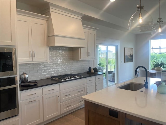 18300 Monrovia St, Overland Park, KS 66013 - kitchen with appliances with stainless steel finishes, custom range hood, decorative backsplash, and white cabinets