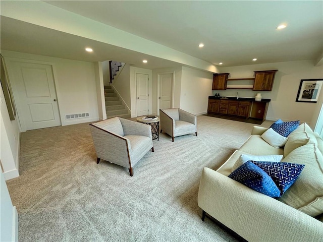 18300 Monrovia St, Overland Park, KS 66013 - living room featuring light colored carpet, recessed lighting, stairs, and wet bar