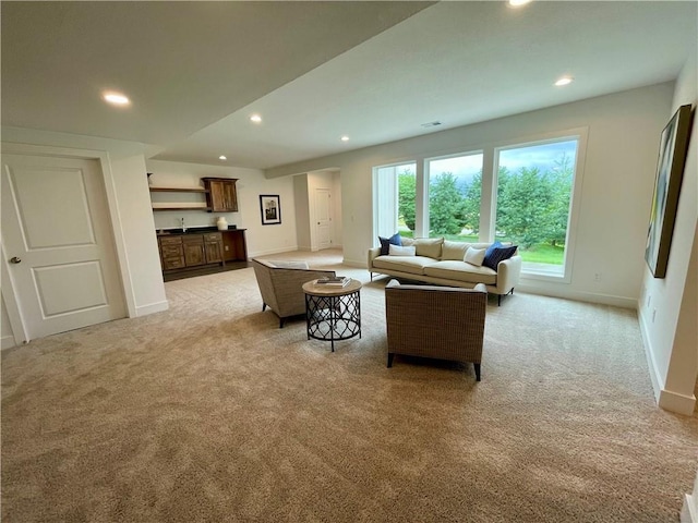 18300 Monrovia St, Overland Park, KS 66013 - living room featuring light carpet, recessed lighting, and bar with sink