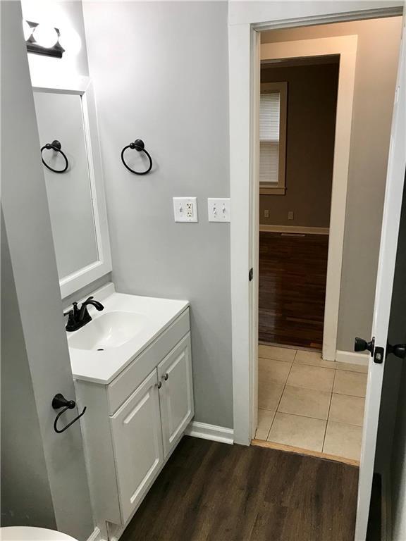 bathroom with hardwood / wood-style flooring and vanity