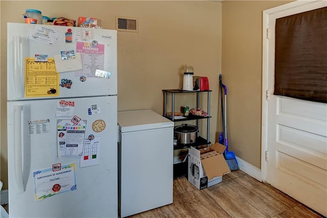 washroom with light hardwood / wood-style floors