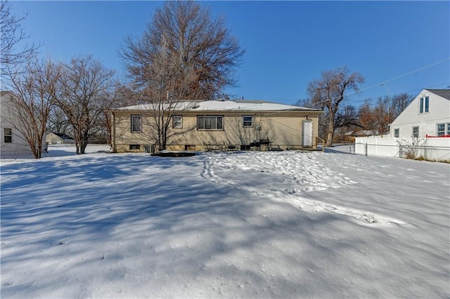 view of snow covered back of property