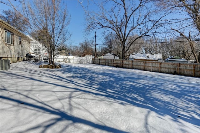 yard covered in snow featuring cooling unit