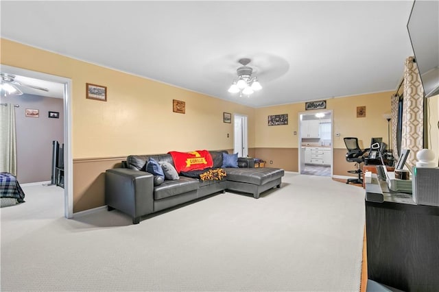 living room with ceiling fan and carpet