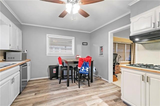 kitchen featuring light wood-type flooring, ceiling fan, stainless steel appliances, and white cabinets