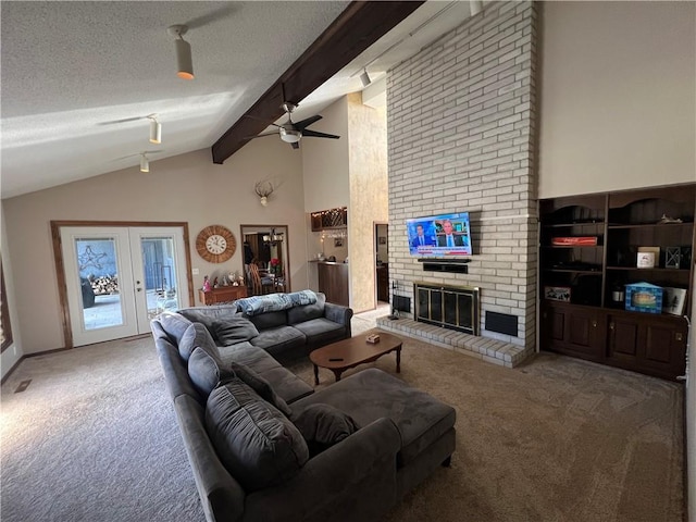 carpeted living area featuring a fireplace, a textured ceiling, a ceiling fan, and vaulted ceiling with beams