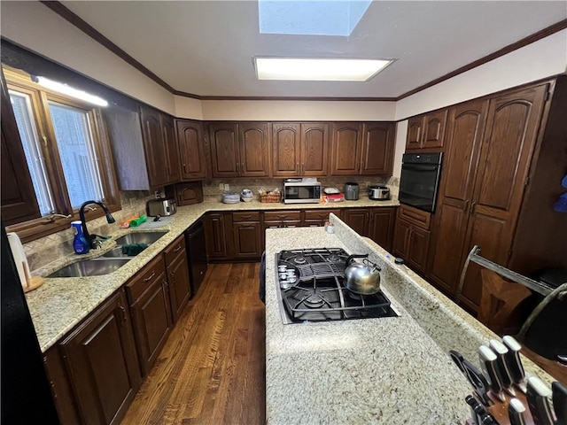 kitchen with tasteful backsplash, black appliances, ornamental molding, a sink, and dark wood-style floors