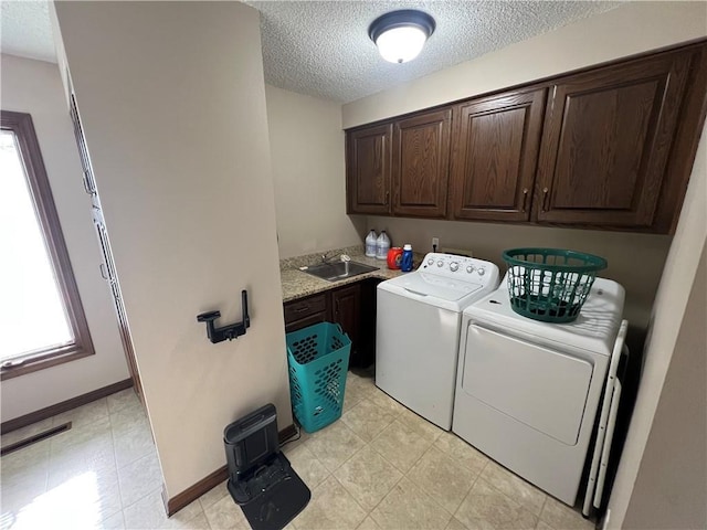 laundry area with a sink, cabinet space, visible vents, a textured ceiling, and washer and dryer