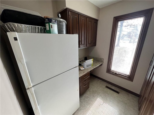 interior space featuring baseboards and visible vents