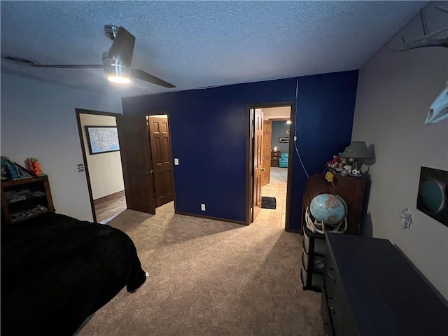 bedroom featuring ceiling fan, a textured ceiling, and carpet flooring
