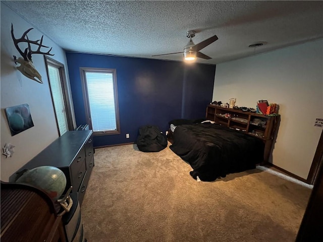 bedroom with a textured ceiling, carpet flooring, and baseboards