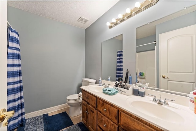 bathroom featuring a shower with shower curtain, vanity, a textured ceiling, tile patterned floors, and toilet