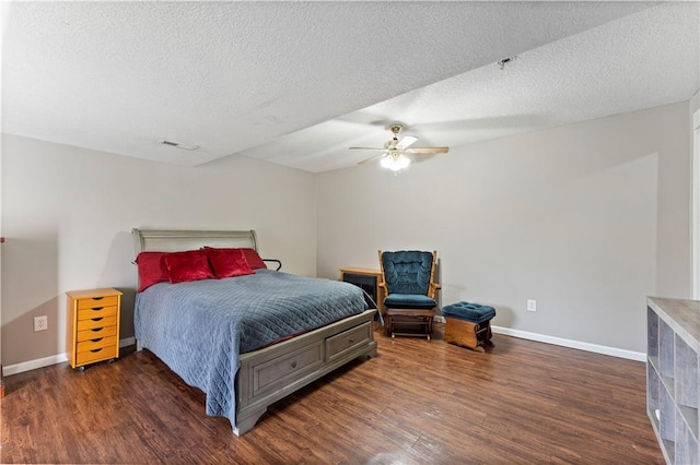 bedroom featuring ceiling fan, a textured ceiling, and dark hardwood / wood-style flooring