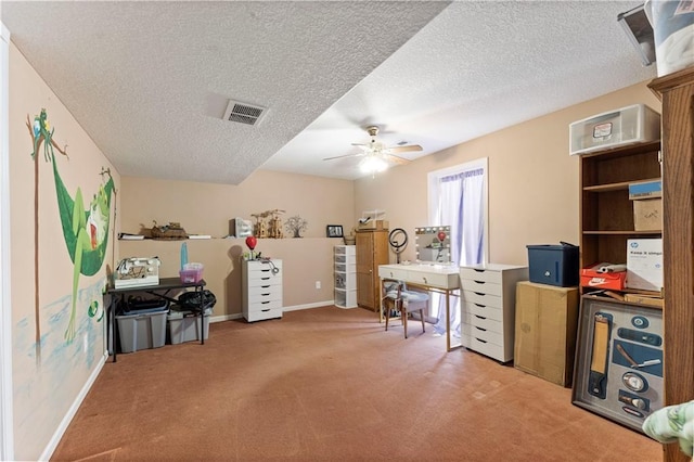 office featuring ceiling fan, carpet floors, and a textured ceiling