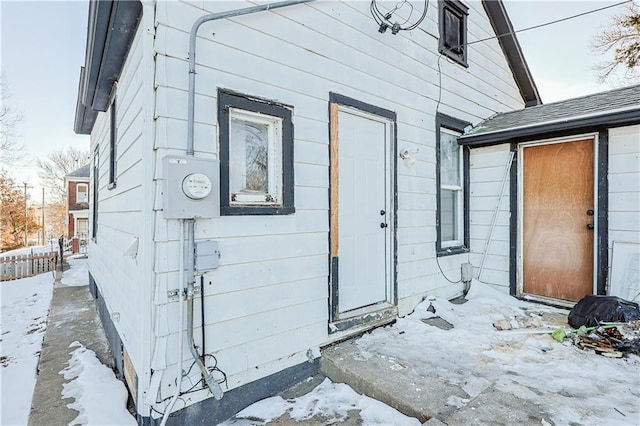 view of snow covered property entrance