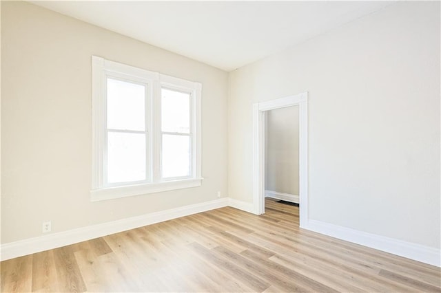 empty room with light hardwood / wood-style flooring