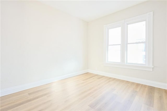 empty room featuring a wealth of natural light and light hardwood / wood-style floors