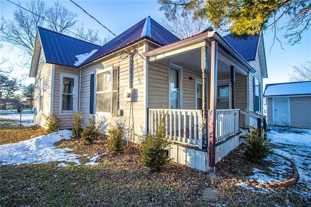 snow covered property featuring a porch