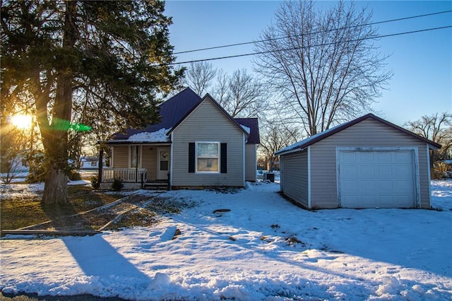 bungalow featuring covered porch, a garage, and an outbuilding