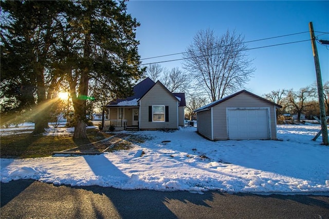 view of front of house with a garage, an outbuilding, and a porch