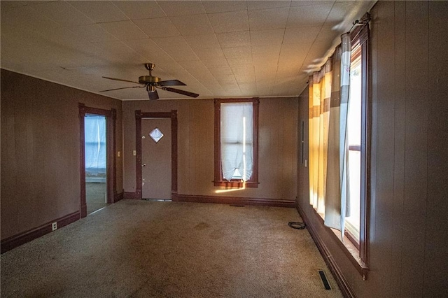 carpeted entryway featuring ceiling fan