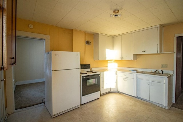 kitchen featuring sink, white appliances, and white cabinetry