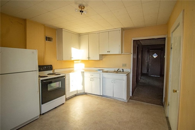 kitchen with white cabinets, sink, and white appliances