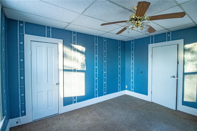 spare room with ceiling fan, carpet flooring, and a paneled ceiling