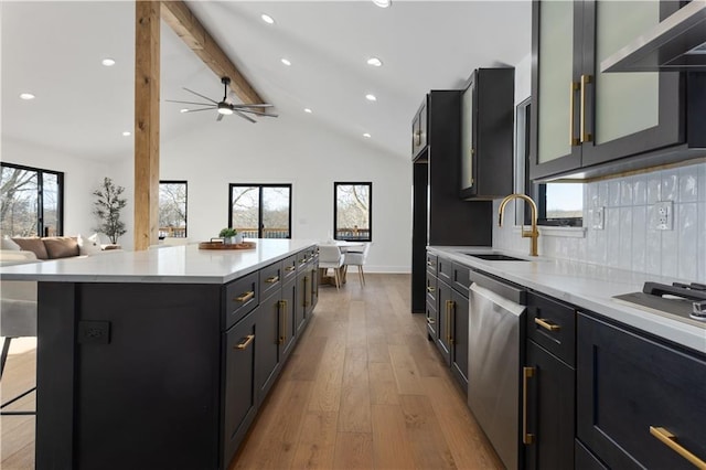 kitchen featuring a kitchen island, a kitchen bar, decorative backsplash, sink, and stainless steel dishwasher