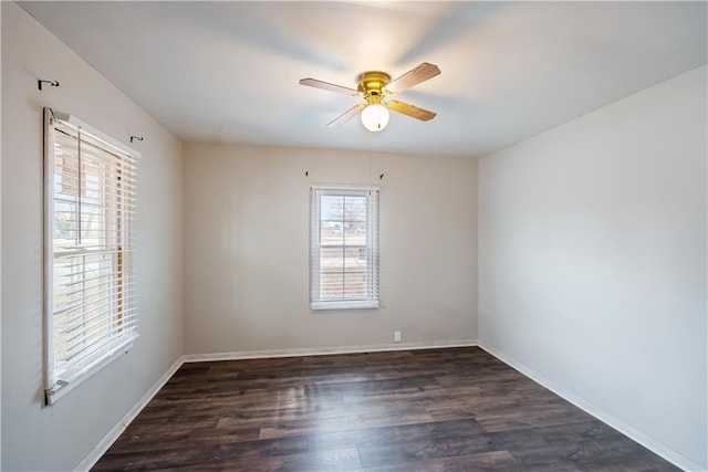 empty room with ceiling fan and dark wood-type flooring