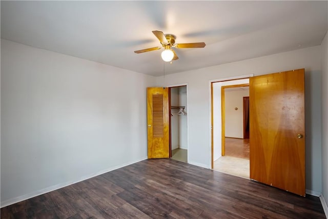 unfurnished bedroom featuring dark wood-type flooring, ceiling fan, and a closet