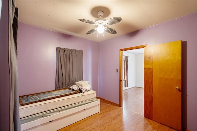 bedroom with ceiling fan and light hardwood / wood-style floors