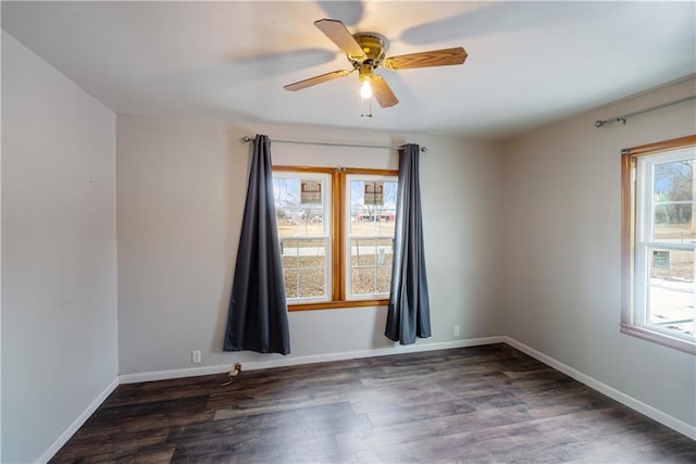 empty room featuring dark wood-type flooring and ceiling fan