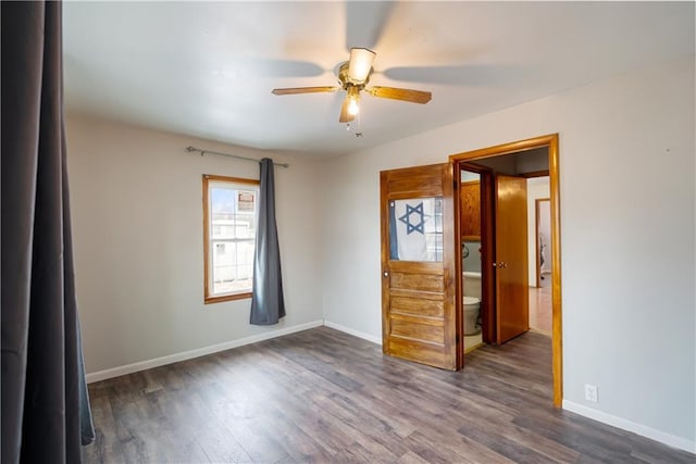 unfurnished bedroom featuring ceiling fan and dark wood-type flooring