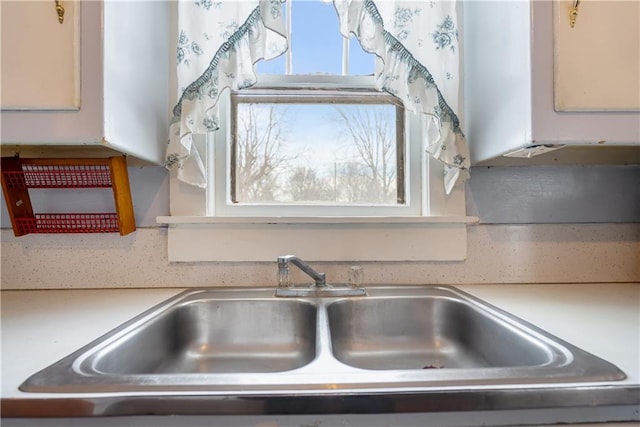 room details with white cabinetry and sink