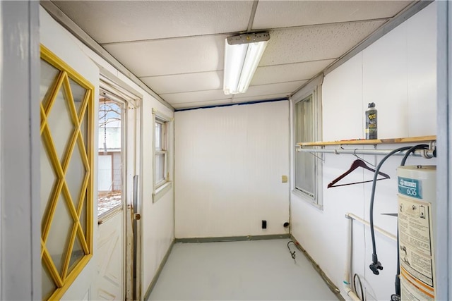 clothes washing area featuring water heater