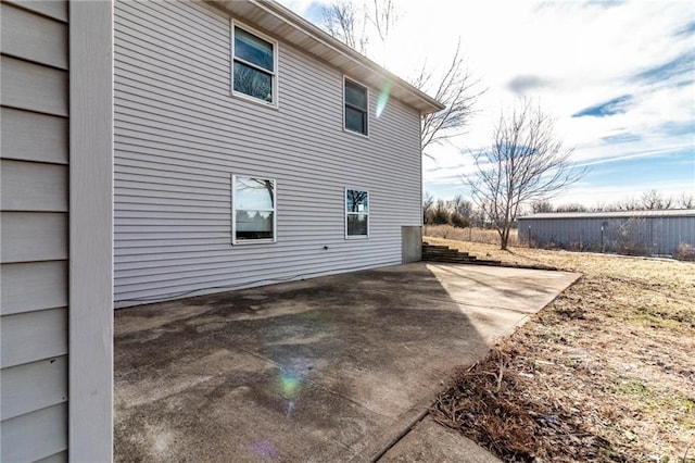 view of side of property with a patio