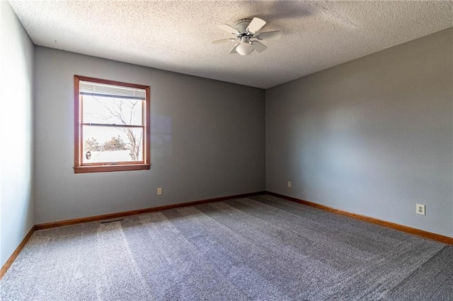 spare room featuring ceiling fan, carpet floors, and a textured ceiling