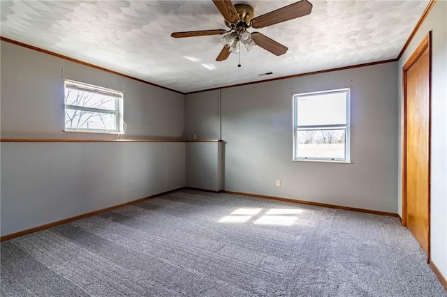 unfurnished room featuring crown molding, carpet flooring, and ceiling fan