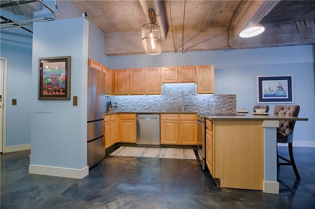 kitchen with appliances with stainless steel finishes, light brown cabinetry, a kitchen breakfast bar, and kitchen peninsula