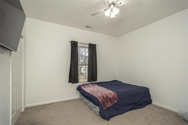 bedroom with ceiling fan and light colored carpet