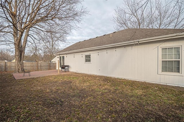 back of property with a yard and a patio