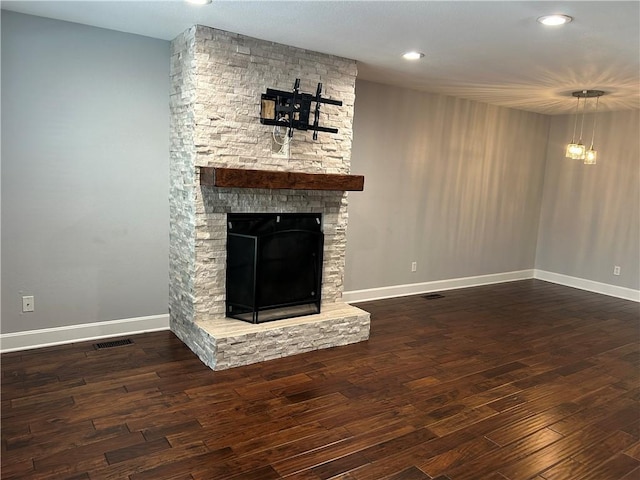 unfurnished living room featuring a fireplace and dark hardwood / wood-style floors