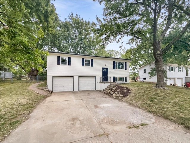 split foyer home with a front yard and a garage