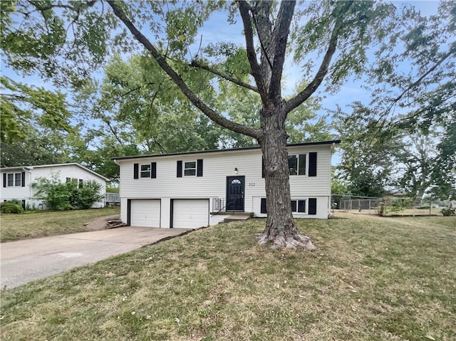 raised ranch with a garage and a front yard