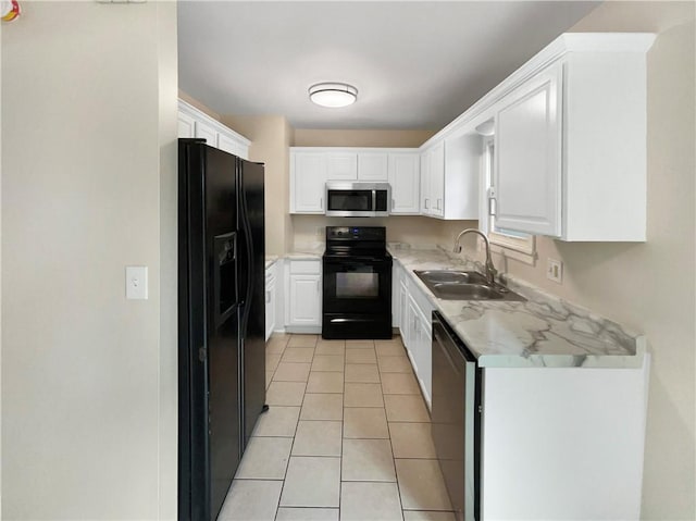 kitchen featuring light tile patterned flooring, sink, white cabinets, and black appliances