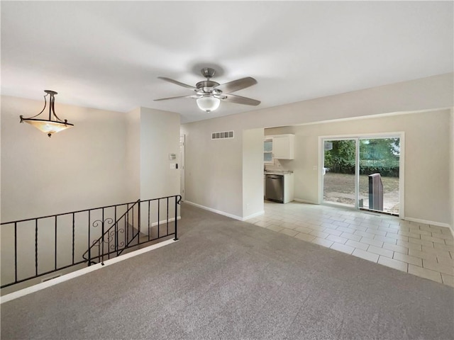 tiled empty room featuring ceiling fan